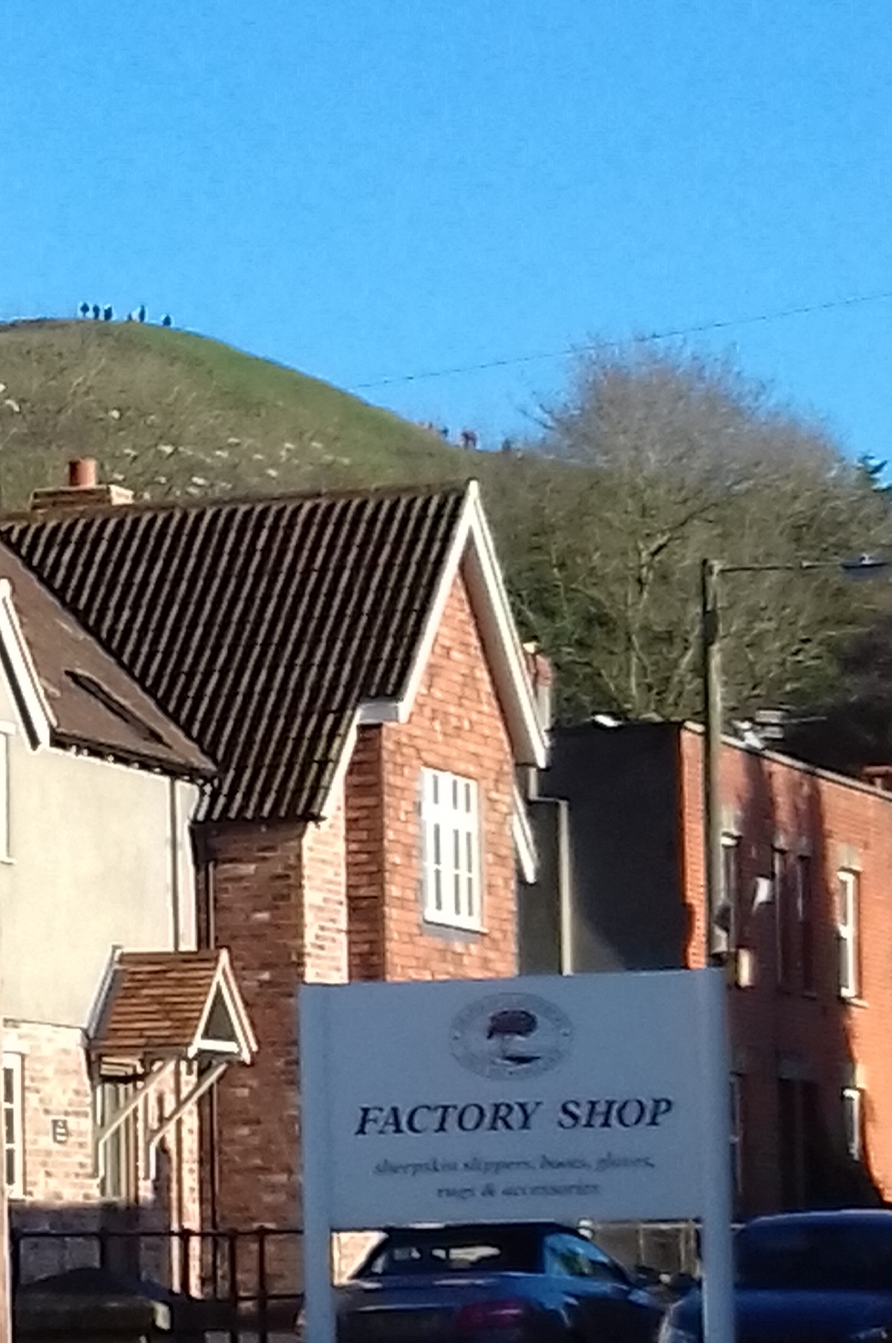 A sign for the car park with the Tor in the back