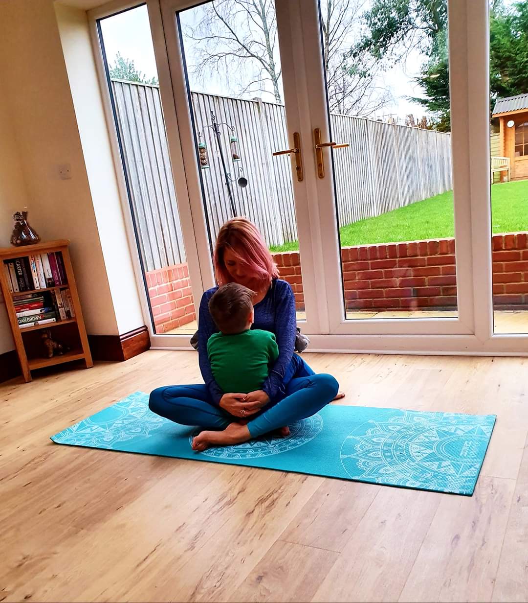 Rachael and her little boy cuddling on the mat