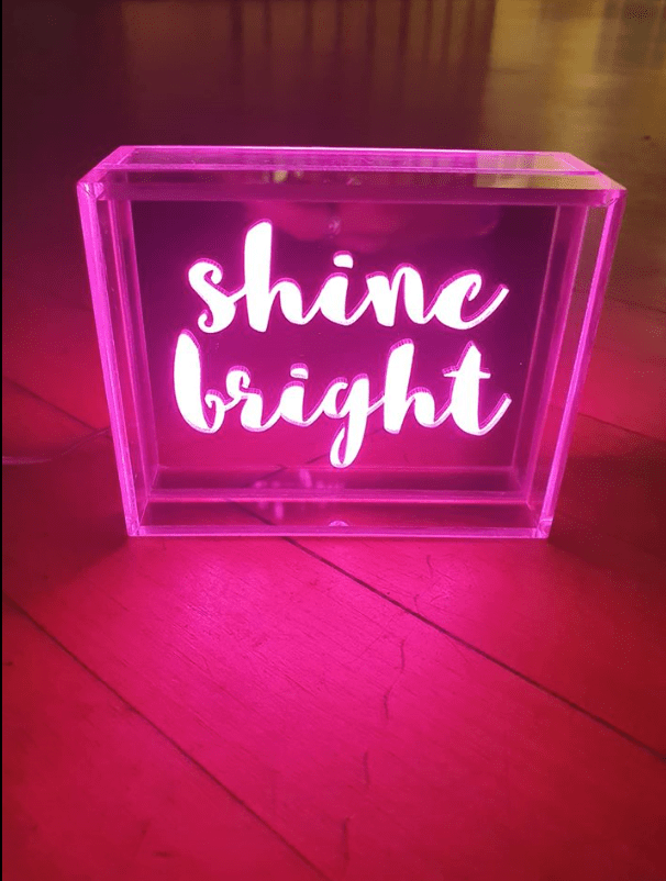 Glowing pinks letters spelling shine bright