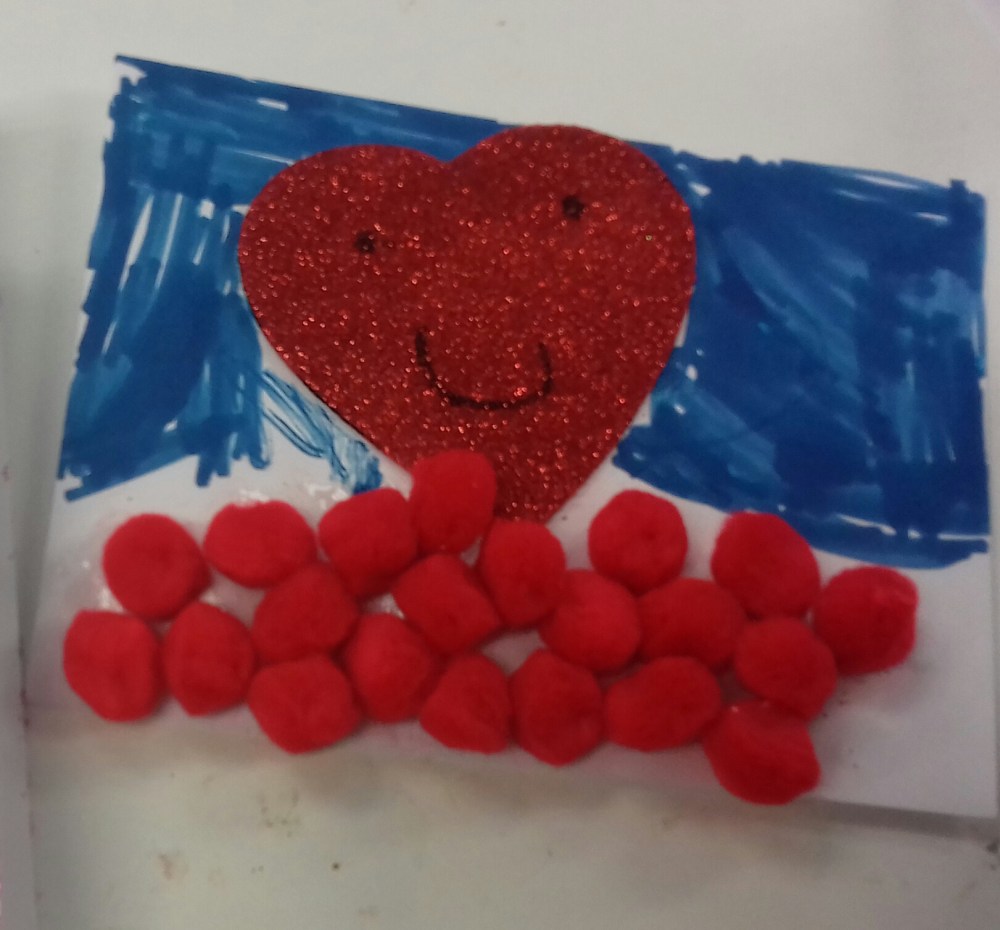 A child's drawing of a red heart with smiley face and a blue felt tip sky