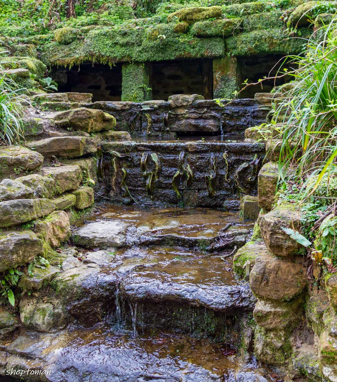 Water cascading down a stone water feature