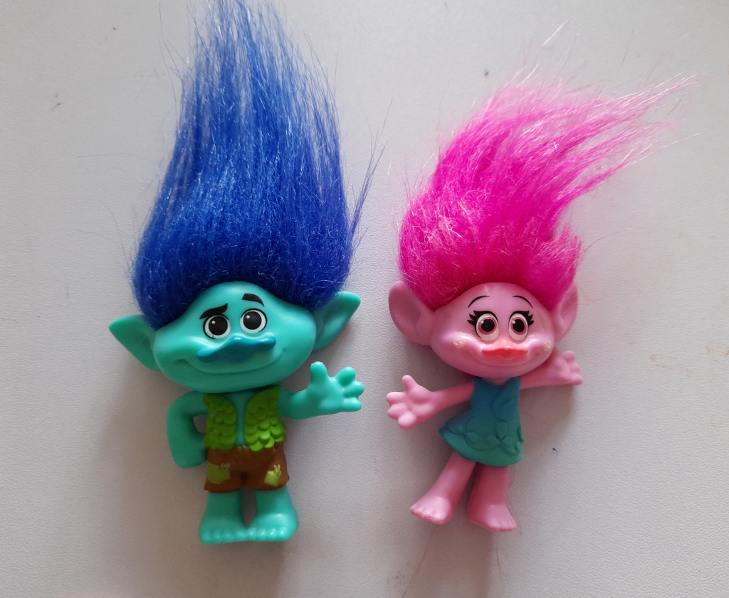 A blue haired boy troll and a pink haired girl troll