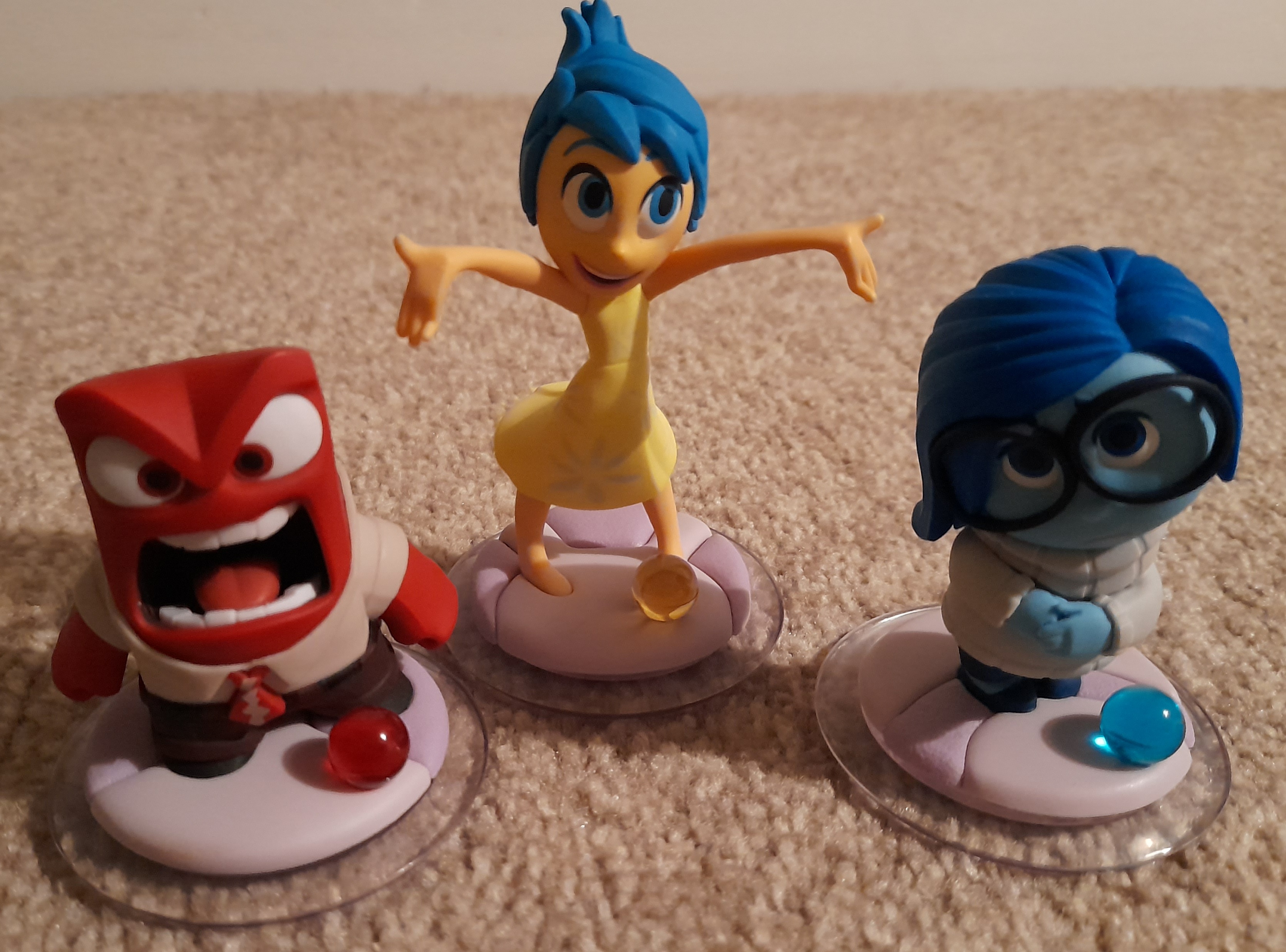 Three characters red is Anger, yellow is Joy and blue is Sadness