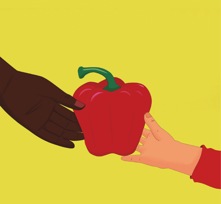 A red pepper against a yellow background handed from one hand to another