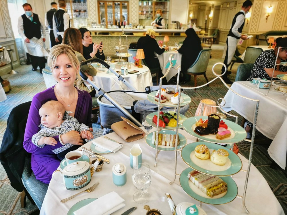 Clare in a purple dress with Sonny in Fortnum and Mason