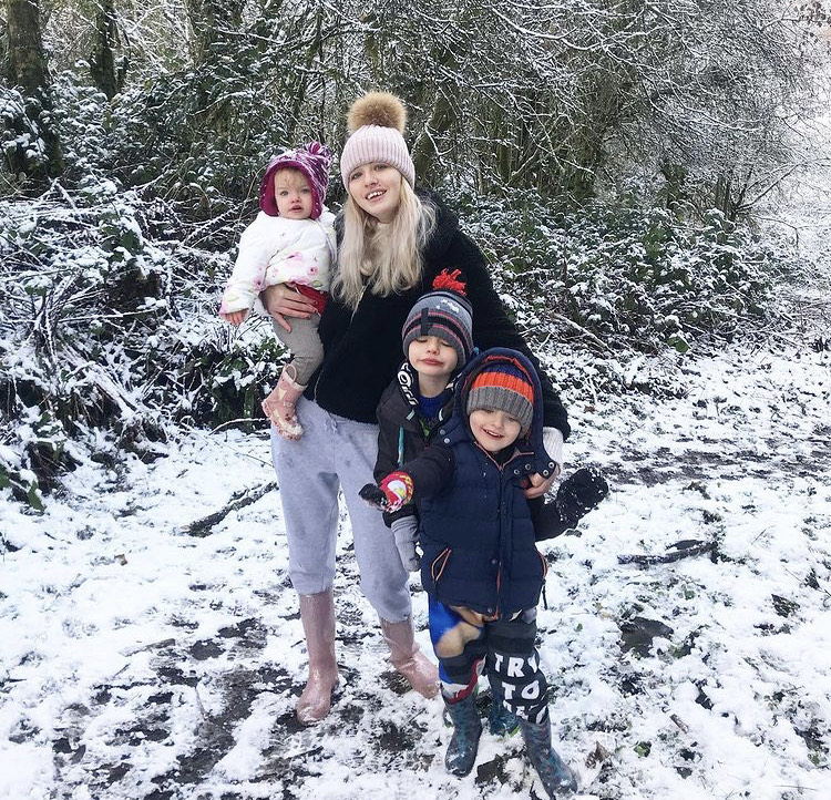 A snowy scene a mum with her 3 children age 7 and under