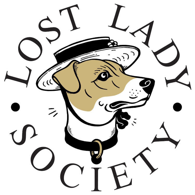 A logo reads LOST LADY SOCIETY in bold black writing circling a beagle in a stylish hat