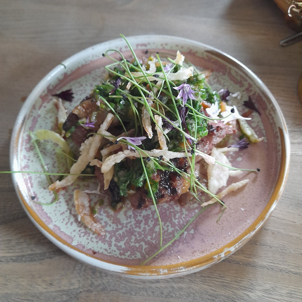 Strips of Somerset sirloin decorated with herbs and edible pansies