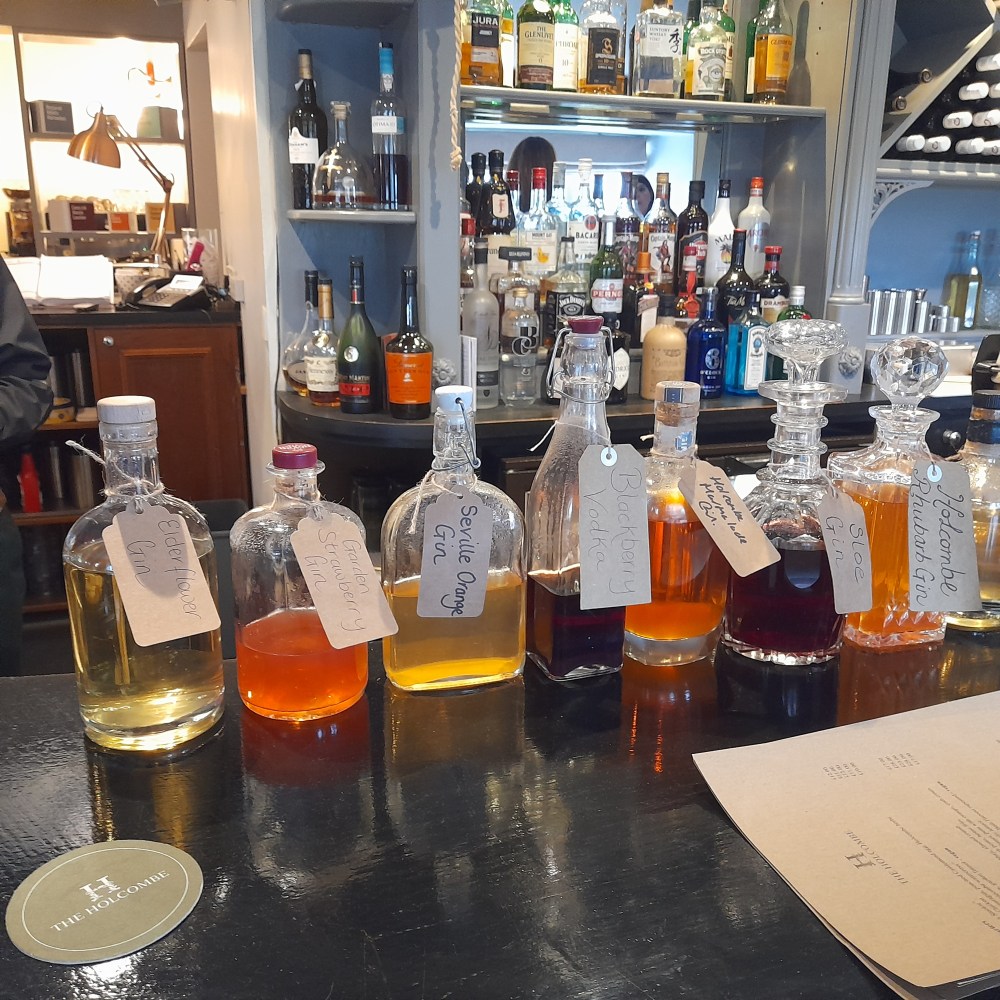 Flavoured gins in a colourful row along a bar