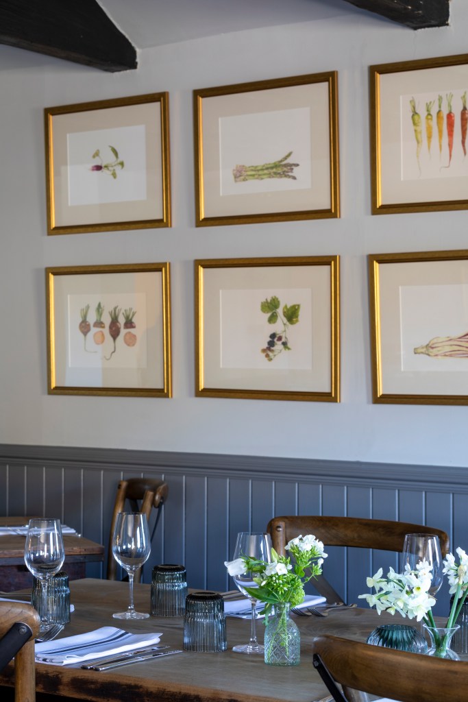 Framed in gold, kitchen drawings of home grown veg